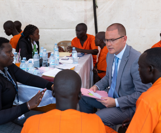 Adam Clinton with a client during a Prison Project